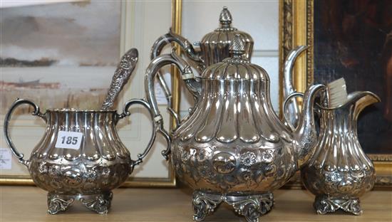 A four piece plated tea set and two silver brushes